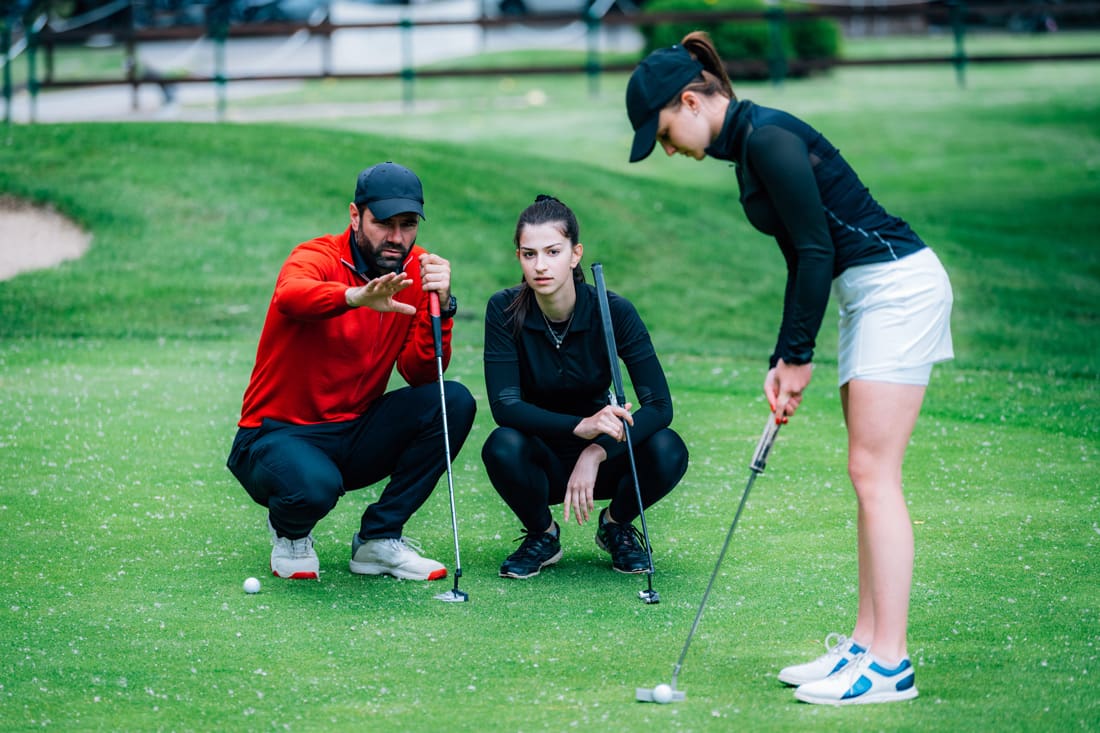 Pro lesson instructor guides two women golfers on the course  - Salida Golf Course collegiate peaks best views and affordable golf in the Colorado Rockies