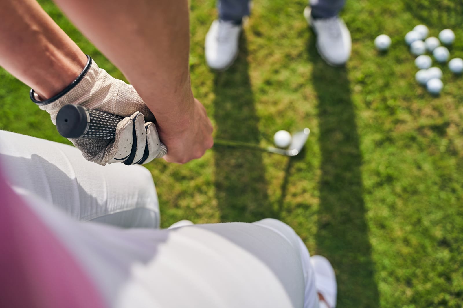 Woman golfer holds putter in hand  - Salida Golf Course collegiate peaks best views and affordable golf in the Colorado Rockies